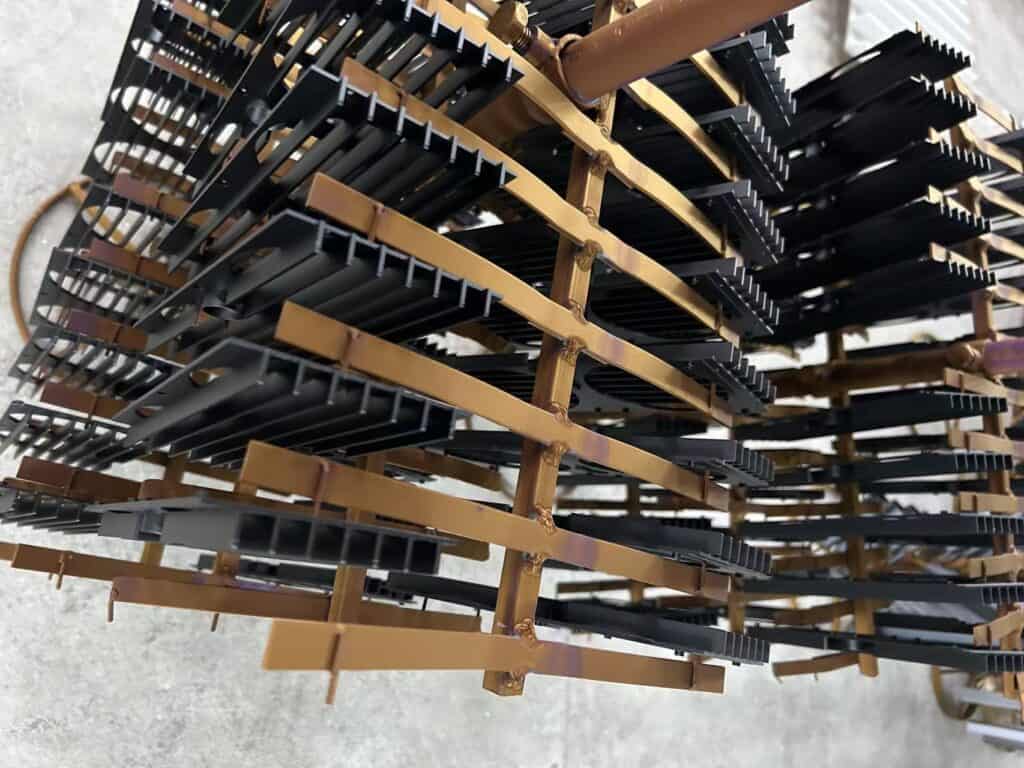Aluminum Heat Sinks Have Been Black Anodized and are Hanging on the Racks