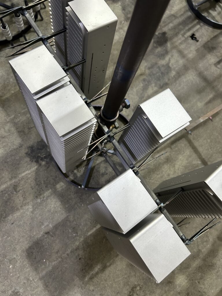 Clear anodized aluminum heat sinks hanging on finishing racks